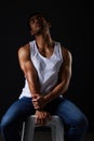 Beauty, muscle and sexy man on chair in studio with fitness inspiration, aesthetic and bodybuilder fashion. Art, healthy