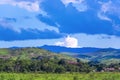 Beauty in nature summer landscape. Amazing blue sky with beautiful clouds, mountains, field with green grass. Aerial rural view in Royalty Free Stock Photo