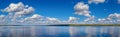 Beauty in nature summer landscape. Clear river, blue sky with beautiful  white clouds, reflecting in calm water. Amazing panoramic Royalty Free Stock Photo