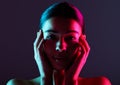 Beauty, neon shadow light and portrait of woman with dark lighting, facial cosmetics and skincare glow. Luxury studio