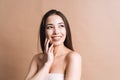 Beauty nude portrait of happy young beautiful asian woman with healthy dark long hair in top bando on beige background isolated Royalty Free Stock Photo