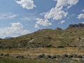 Outdoors in Wyoming, with buttes and rock formations on the mountaintops