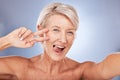 Beauty, peace sign selfie and mature woman for skincare, health and wellness with silly and goofy expression on a studio Royalty Free Stock Photo