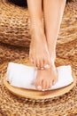 Beauty, pedicure and feet of person on towel and basket for grooming, spa treatment and wellness. Luxury aesthetic Royalty Free Stock Photo