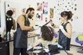 Beauty and people concept - happy young woman with hairdresser coloring hair Royalty Free Stock Photo