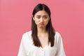 Beauty, people emotions and summer leisure concept. Depressed and sad young asian woman in white dress, pouting and Royalty Free Stock Photo