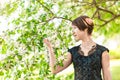 Beauty, people, summer and spring concept - beautiful young woman over green blooming garden background Royalty Free Stock Photo