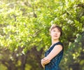 Beauty, people, summer and spring concept - beautiful young woman over green blooming garden background Royalty Free Stock Photo