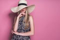 Beauty photo of attractive sensual woman wearing straw brimmed hat, posing on pink studio background. Girl with glamour Royalty Free Stock Photo