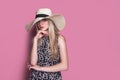 Beauty photo of attractive sensual woman wearing straw brimmed hat, posing on pink studio background. Girl with glamour Royalty Free Stock Photo