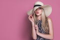 Beauty photo of attractive sensual woman wearing straw brimmed hat, posing on pink studio background. Girl with glamour Royalty Free Stock Photo