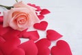 Beauty pink-orange rose and red satin hearts shape on wooden floor. Valentine's day background concept