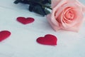 Beauty pink-orange rose and red satin hearts shape on wooden floor. Valentine& x27;s day background concept Royalty Free Stock Photo