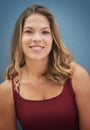 Beauty plain and simple. Portrait of a smiling young woman posing against a gray background. Royalty Free Stock Photo