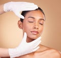 Beauty, plastic surgery and hands with face of Indian woman in studio for cosmetics and skincare. Spa treatment Royalty Free Stock Photo