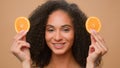 Beauty portrait African American girl woman cover eyes with two slices of orange smiling laughing diet vegetarian Royalty Free Stock Photo