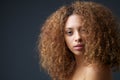 Beauty portrait of an attractive female fashion model with curly hair Royalty Free Stock Photo