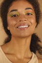 Beauty portrait of attractive young african american woman with neon color make-up smiling at camera Royalty Free Stock Photo