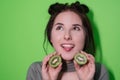 Beauty portrait of attractive young woman with clean radiant skin face with kiwi halves, brunette girl with bare Royalty Free Stock Photo