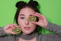 Beauty portrait of attractive young woman with clean radiant skin face with kiwi halves, brunette girl with bare Royalty Free Stock Photo