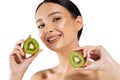 Young woman with clean radiant skin showing kiwi halves, on white background, beauty and skin care concept Royalty Free Stock Photo