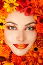 Beauty portrait of beautiful female face with orange flowers