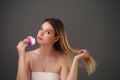 Beauty Portrait. Beautiful Stylish Girl with Orchid Flower. Perfect Face Skin. Healthy hair Royalty Free Stock Photo