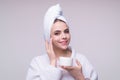 Beauty portrait of a beautiful woman applying face cream. Woman applying moisturizing skincare cream, lotion or mask for Royalty Free Stock Photo