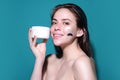 Beauty portrait of a beautiful woman applying face cream. Woman applying moisturizing skincare cream, lotion or mask for Royalty Free Stock Photo