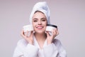 Beauty portrait of a beautiful woman applying face cream. Woman applying moisturizing skincare cream, lotion or mask for Royalty Free Stock Photo