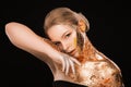 Beauty portrait of blonde girl with golden foil on her face, neck and shoulders Royalty Free Stock Photo