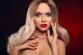 Beauty portrait of blonde woman with red lips, long healthy shiny blond hair style and manicured nails looking at camera. Sensual Royalty Free Stock Photo