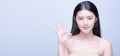 Beauty portrait of cheerful attractive half naked asian woman with smiling face showing ok gesture sign and looking forward at