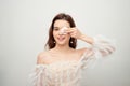 Beauty portrait of a cheerful young topless woman removing face make-up with a cotton pad isolated over gray background Royalty Free Stock Photo