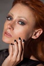 Beauty portrait closeup of a young red head woman.