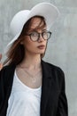 Beauty portrait cute young girl with pretty lips in trendy glasses in stylish black-white clothes and summer vintage hat on Royalty Free Stock Photo