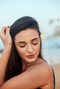 Beauty portrait of female face with natural skin on the sea. Beautiful woman on the beach. Skin care. Royalty Free Stock Photo