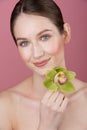 Beauty portrait, gentle makeup, large portrait of girl with a flower, beautiful smile