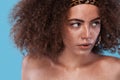 Beauty portrait of girl with afro hairstyle. Girl posing on blue background. Studio shot. Royalty Free Stock Photo