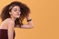 Beauty portrait of girl with afro hairstyle. Girl posing on yellow background, smiling. Studio shot. Royalty Free Stock Photo