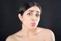 Beauty portrait of a girl with bare shoulders who shows off her lips sending a kiss to the camera