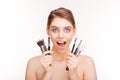 Beauty portrait of happy excited young woman with makeup brushes Royalty Free Stock Photo