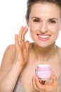 Beauty portrait of happy woman applying creme Royalty Free Stock Photo