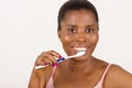 Young girl brushing teeth happily isolated on light background Royalty Free Stock Photo
