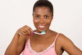 Young girl brushing teeth happily isolated on light background Royalty Free Stock Photo