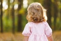 Beauty portrait of a little girl with long hair enjoying nature outdoors, on a field with daisies. The Royalty Free Stock Photo