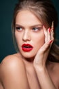 Beauty portrait of pretty woman with red lips, red and gold nails, nails decoration, jewelry.