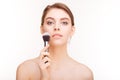 Beauty portrait of sensual charming young woman holding makeup brush Royalty Free Stock Photo