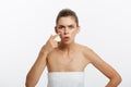 Beauty portrait of a shocked young half naked woman examining her face while looking at the mirror isolated over white Royalty Free Stock Photo