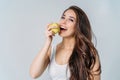 Beauty portrait of smiling young asian woman girl holding green apple near clean face on grey background Royalty Free Stock Photo